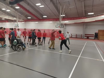 Residents and staff participating in a basketball activity