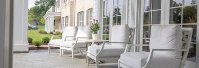 Outdoor seating area with chairs and potted plants