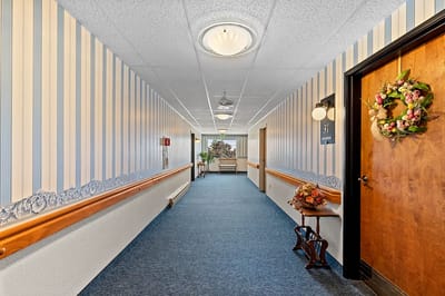 Brightly lit interior hallway with floral decorations
