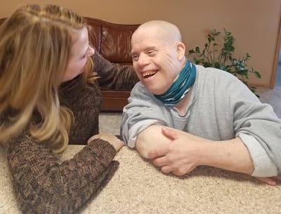 Resident interacting joyfully with staff member