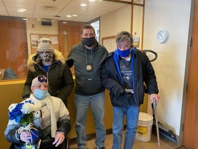 Residents and staff celebrating with flowers