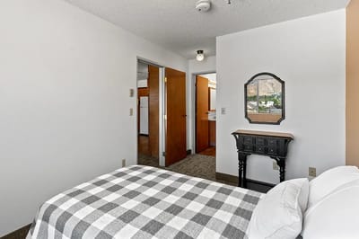Cozy resident room with a bed and mirror