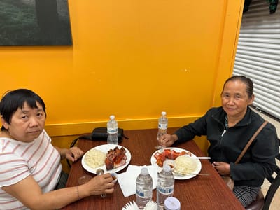 Two residents enjoying a meal together indoors