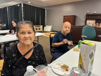 Two residents enjoying a meal in a dining setting