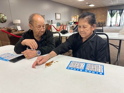 Residents playing bingo in an activity room