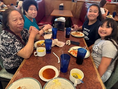 Residents enjoying a meal together in the dining room