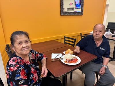 Two residents enjoying a meal in the dining area