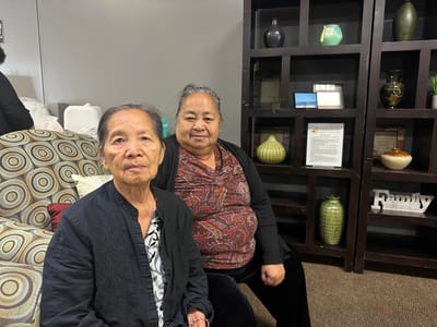 Two women sitting in a common area of the facility