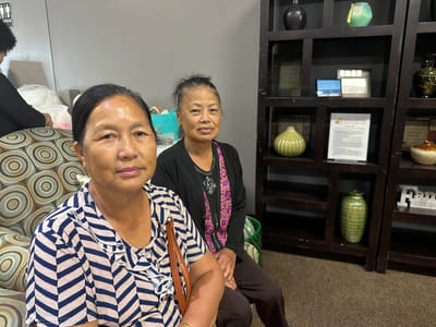 Two residents sitting in a cozy interior space