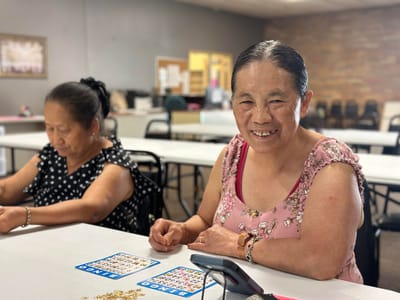 Residents playing bingo in an activity room