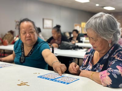 Residents playing bingo in a vibrant activity room