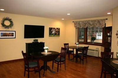 A common area with tables and chairs in a bright room