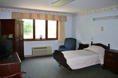 Cozy resident room with a bed and furniture