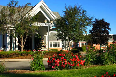 Building exterior with gardens and colorful flowers