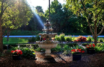 A beautiful outdoor fountain surrounded by flowers