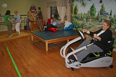Residents engaging in rehabilitation activities in a bright indoor space