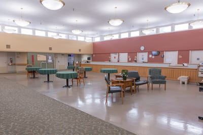 Common area of a senior living facility with tables and chairs
