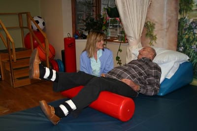 Therapist assisting resident in a therapy session