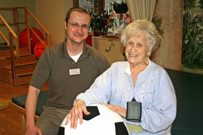 Care staff interacting with a resident during an activity