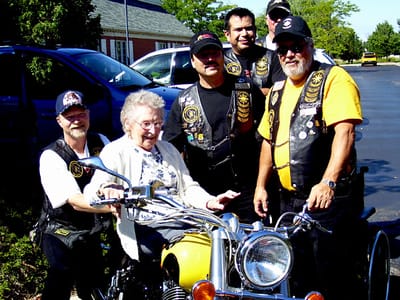 Residents with bikers at an outdoor event
