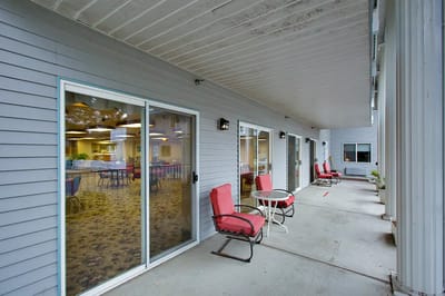 Residents relaxing on a patio area outside