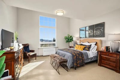 Brightly decorated private resident room with large windows
