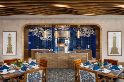 Interior dining area with decorated tables and kitchen view