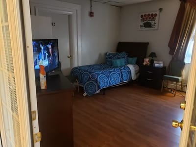 A private resident room with a bed and television