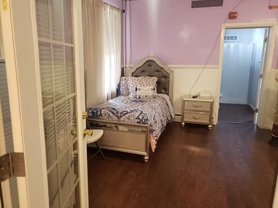 Private resident room with a bed and dresser