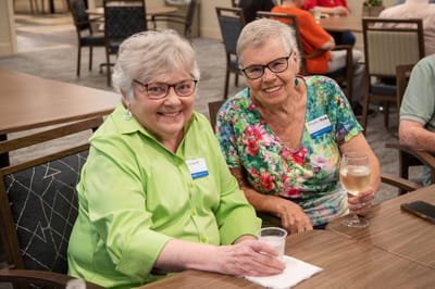 Two smiling residents at a social gathering
