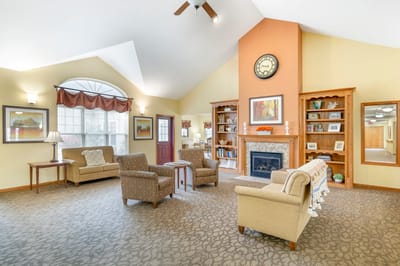 Bright common area with seating and a fireplace