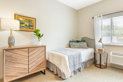 Cozy, well-decorated resident room with bed and furnishings