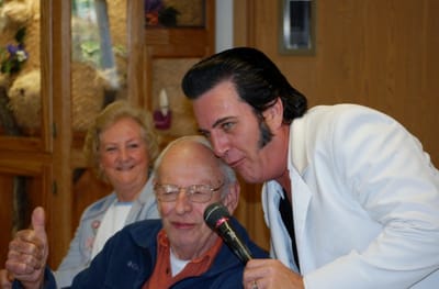 Residents enjoying a performance by an entertainer