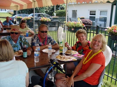 Residents enjoying a meal outside at a community event