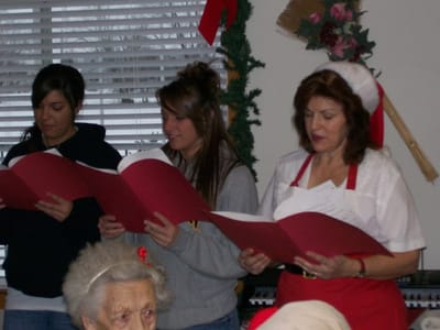 Residents and staff singing carols during a holiday celebration