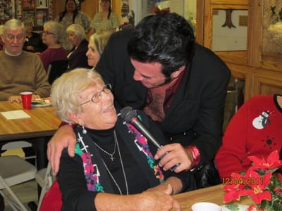 Residents enjoying a musical performance at a social event