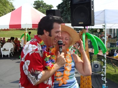 Residents enjoying a festive outdoor activity with live entertainment