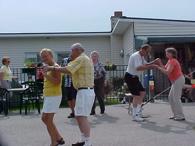 Residents dancing outside at a community event
