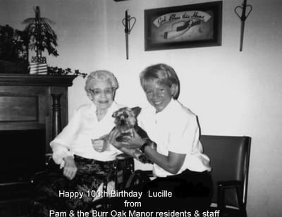 Residents celebrating a 100th birthday with a pet