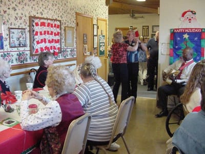 Residents enjoying a dance in a decorated common area