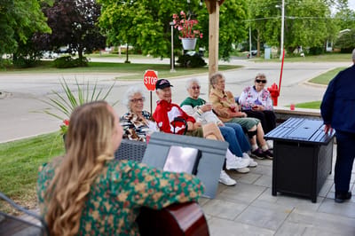 Residents enjoying live music outdoors on a patio.