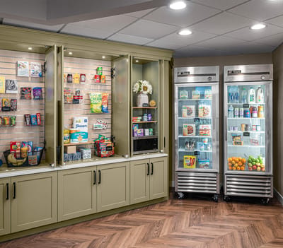 Interior view of a snack area with fridges and shelves