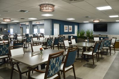 Dining area with tables and chairs in a community room