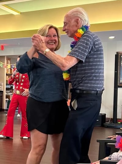 Residents dancing and enjoying an event in the facility
