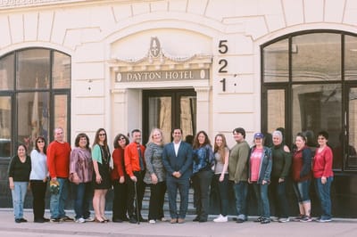 Group of people in front of the Dayton Hotel building