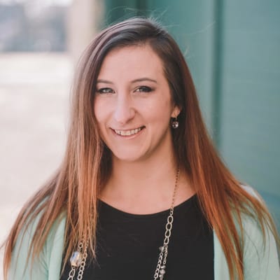 Staff member smiling outdoors in casual attire