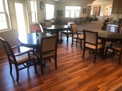 Common area with tables and chairs in a well-lit interior