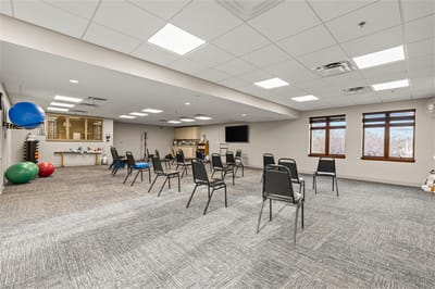 Interior activity room with chairs arranged for social distancing