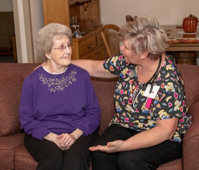 Caregiver interacting with a resident in a cozy common area