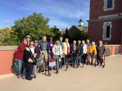 Residents and staff posing outside the facility